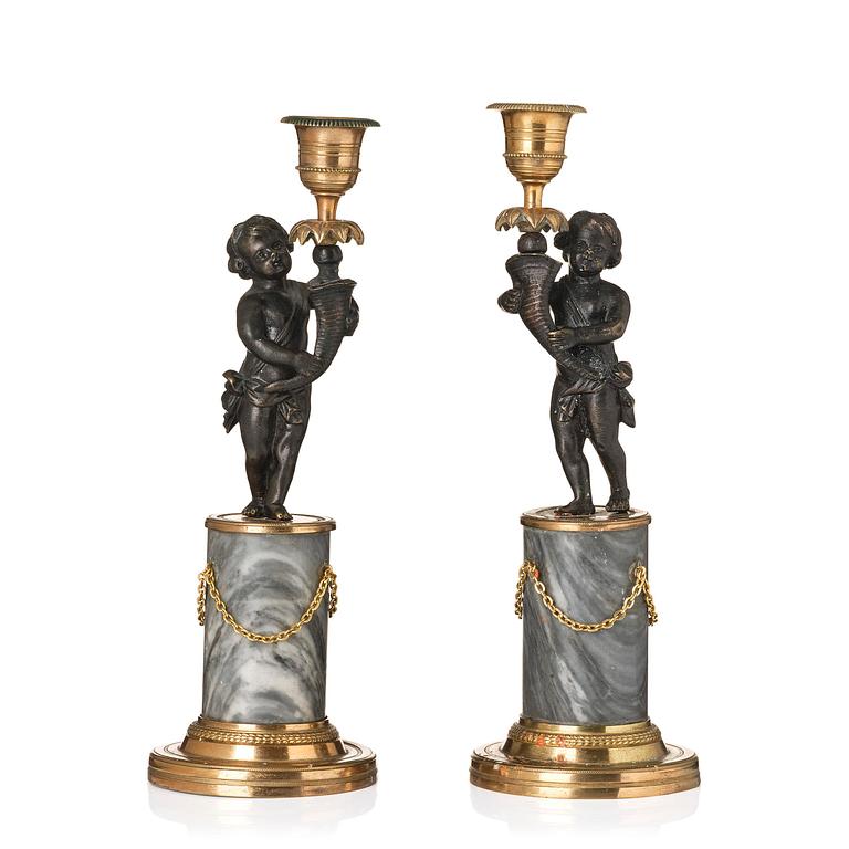A pair of French Louis XVI ormolu and marble candlesticks, late 18th century.