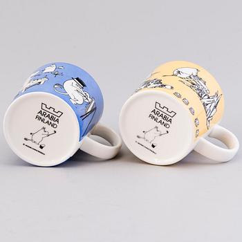 TWO MOOMIN-MUGS, porcelain, 'Mug blue' and 'Mug yellow', Moomin Characters, Arabia 1990-1996.