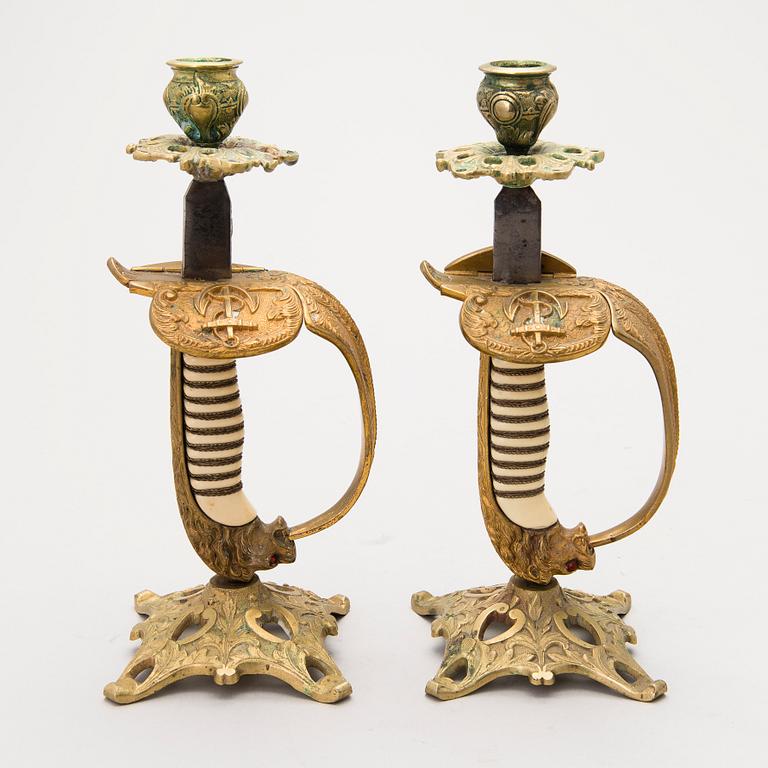 A pair of German sword hilt candlesticks, early 1900s.