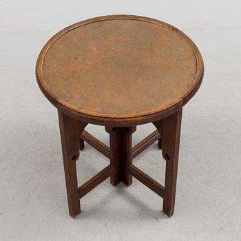 NORDISKA KOMPANIET, an Art Nouveau copper and oak smoking table, 1913.