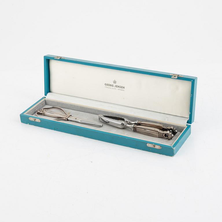 A sterling silver grape scissor and a nutcracker, design Johan Rohde, Georg Jensen, Copenhagen, post 1945.