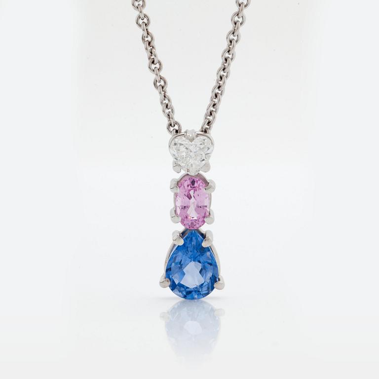 A PENDANT set with sapphires and a heart brilliant-cut diamond.