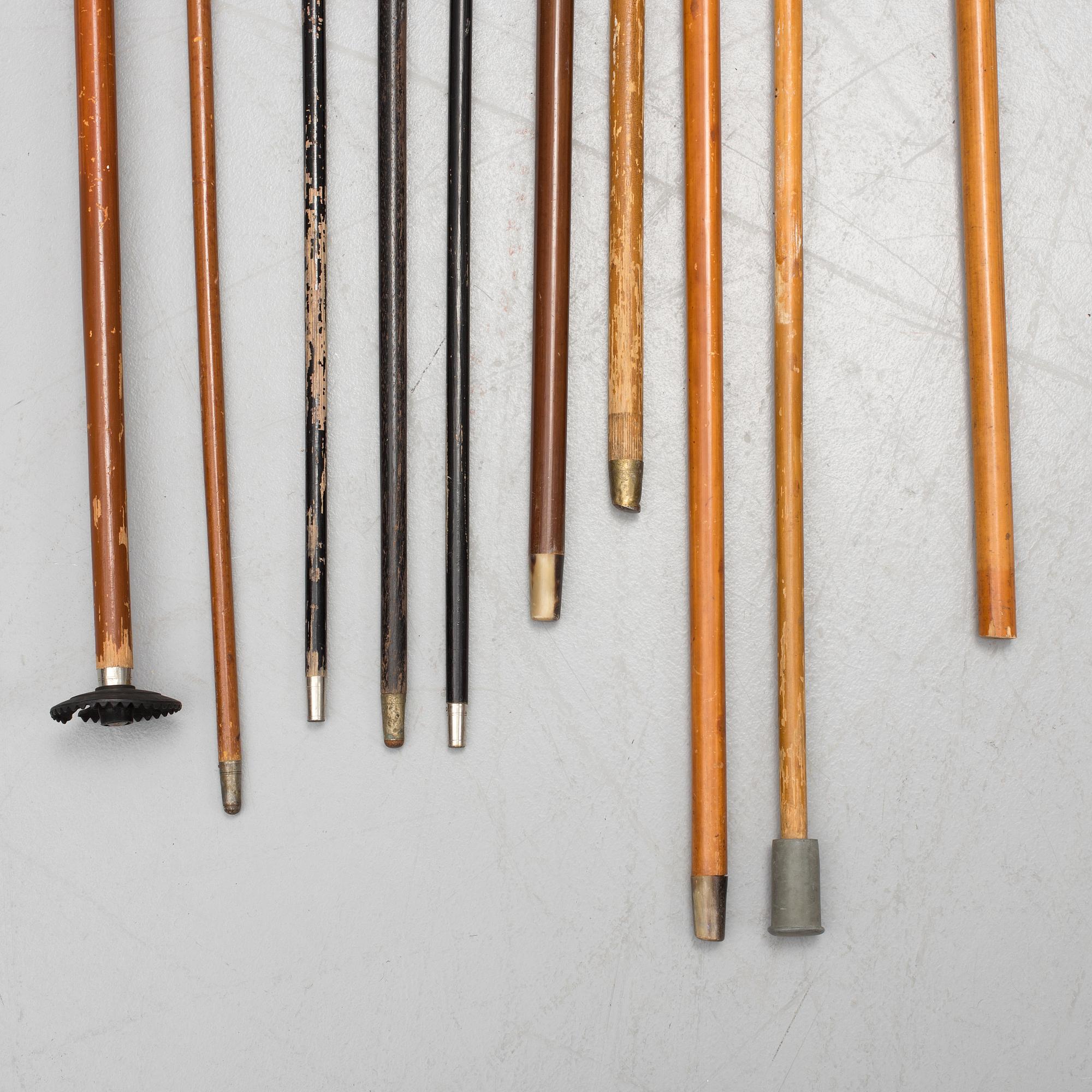 NINE WALKING STICKS, silver handles and a stick with plate handle, first half of the 20th century.