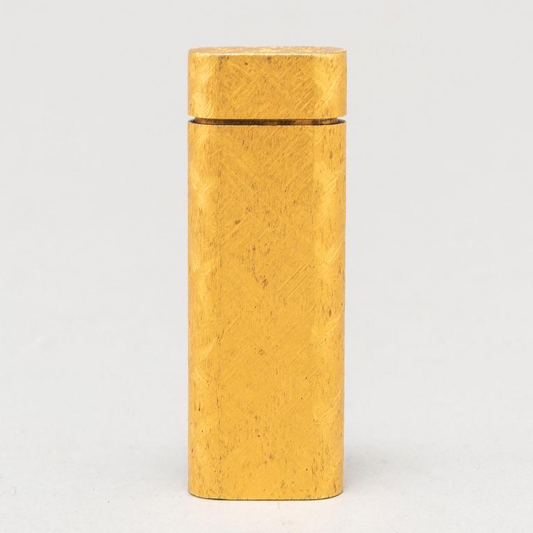 A gilt steel lighter from les must de Cartier.