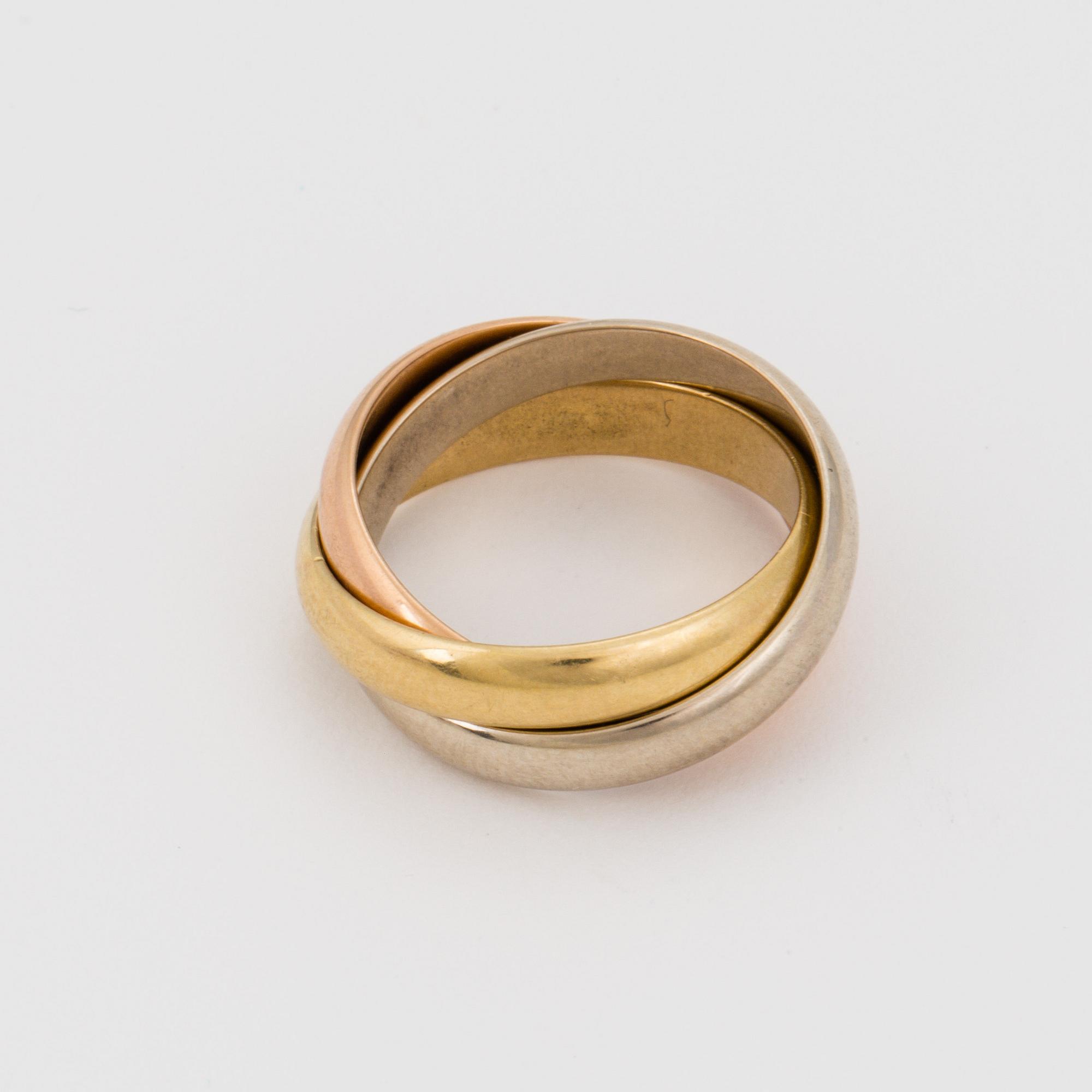 An 18K white, rose and yellow gold ring.