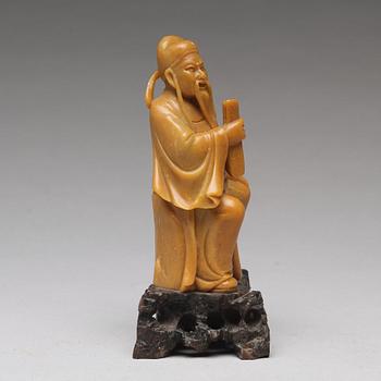 A soapstone figure of a seated scholar, late Qing dynasty, circa 1900.