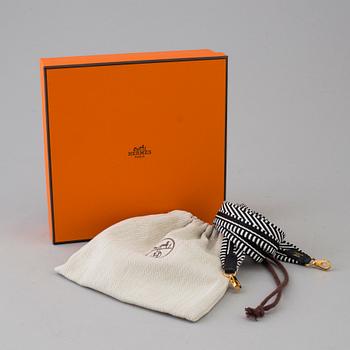 A bag strap by Hermès.