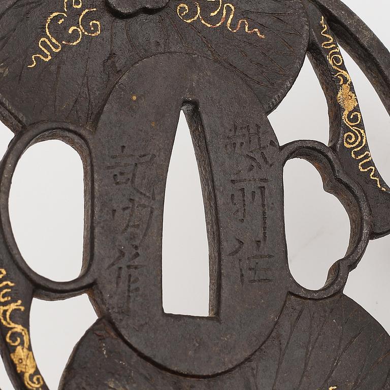 Three iron tsuba with gold inlay, two signed, Edo period.