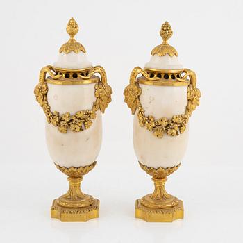 A pair of French Louis XVI-style Napoleon III gilt-bronze and marble urns, latet part of the 19th century.