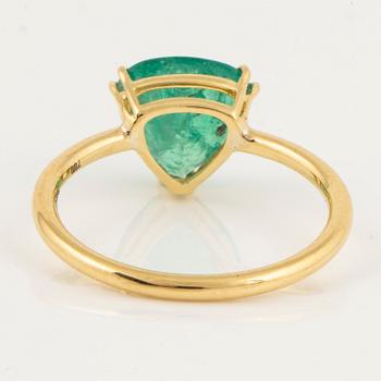 Triangle shaped emerald and brilliant-cut diamond ring.