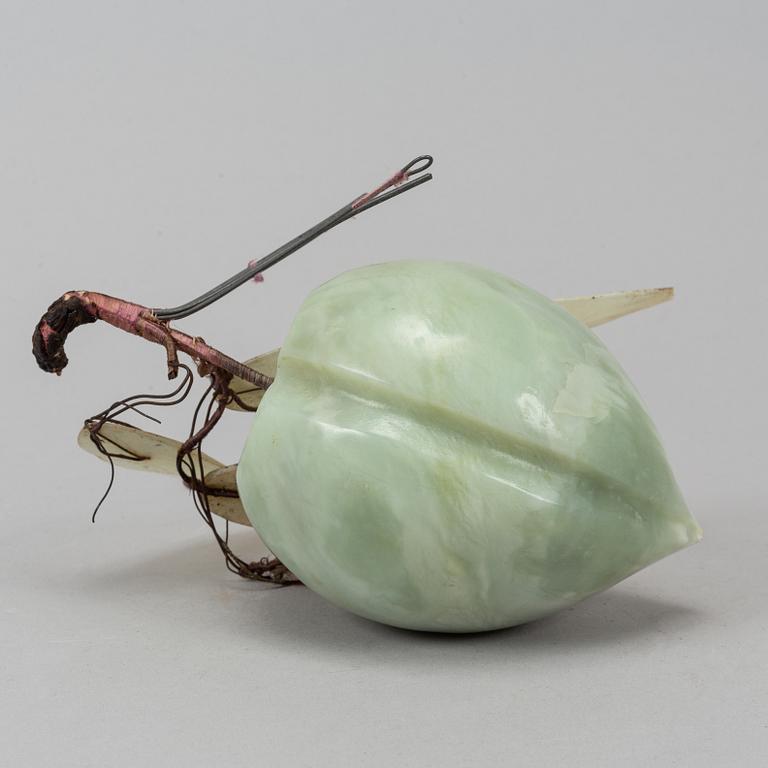 A nephrite carving of a peach, China, mid 20th Century.