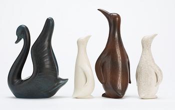 Four Gunnar Nylund stoneware figures, a swan and three penguins, Rörstrand.