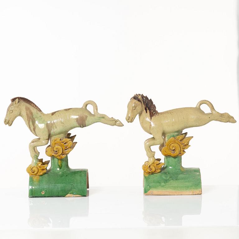 A set of two green and yellow glazed roof tiles figures of flying horses, Qing dynasty.