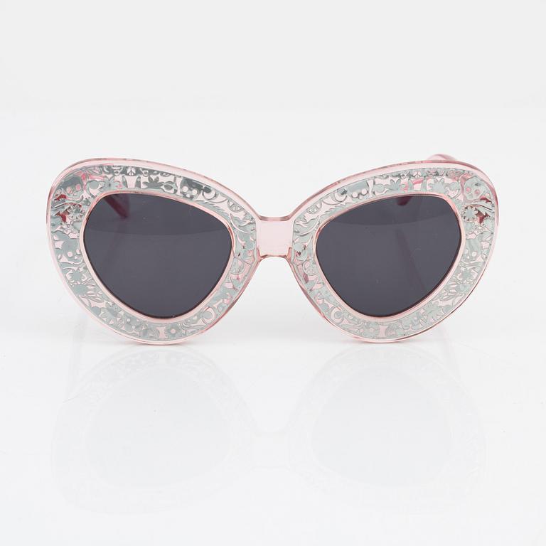 Karen Walker, a pair of pink "Intergalactic" sunglasses.