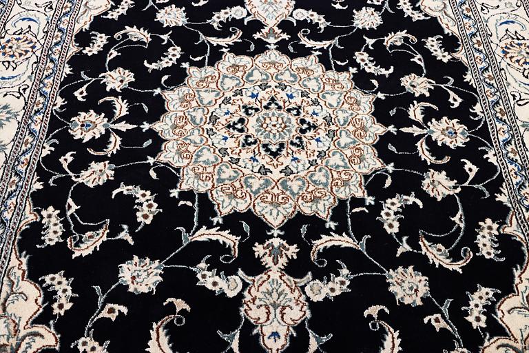 A Nain carpet, part silk, c. 303 x 200 cm.