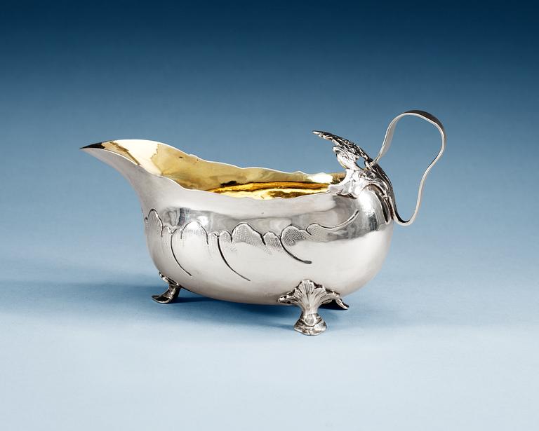 A SWEDISH PARCEL-GILT CREAM JUG, Makers mark of Lars Boye, Stockholm 1769.