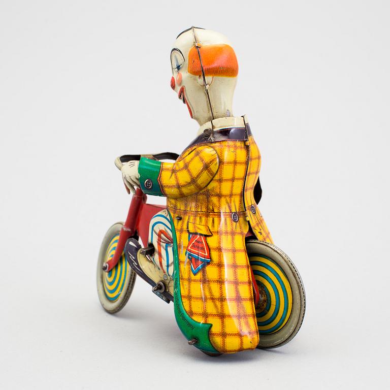 A tinplate Technofix bicycling clown Germany c. 1950.