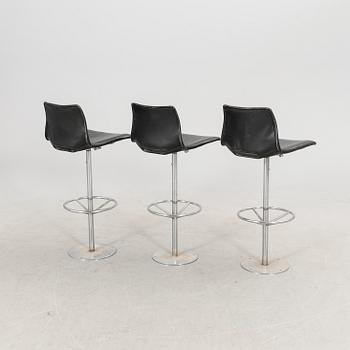 A set of three late 20th century metal and leather bar stools.