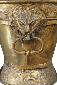 A Baroque brass wine cooler.