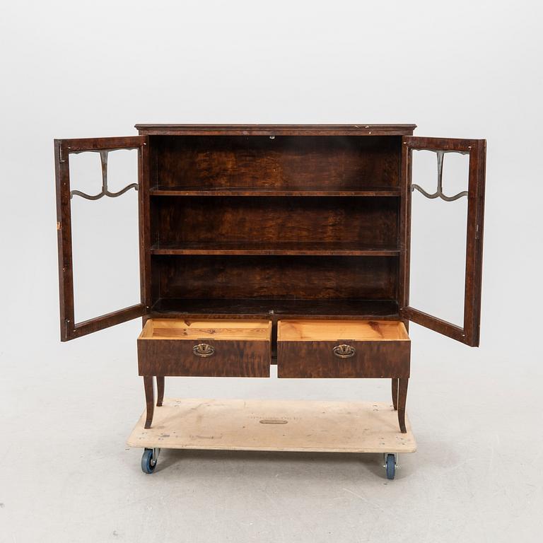 A 1920s  stained beech display cabinet.