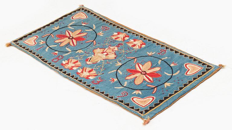 An embroidered carrige cushion, c. 92 x 44 cm, Scania, Sweden, signed BD and dated 1839.