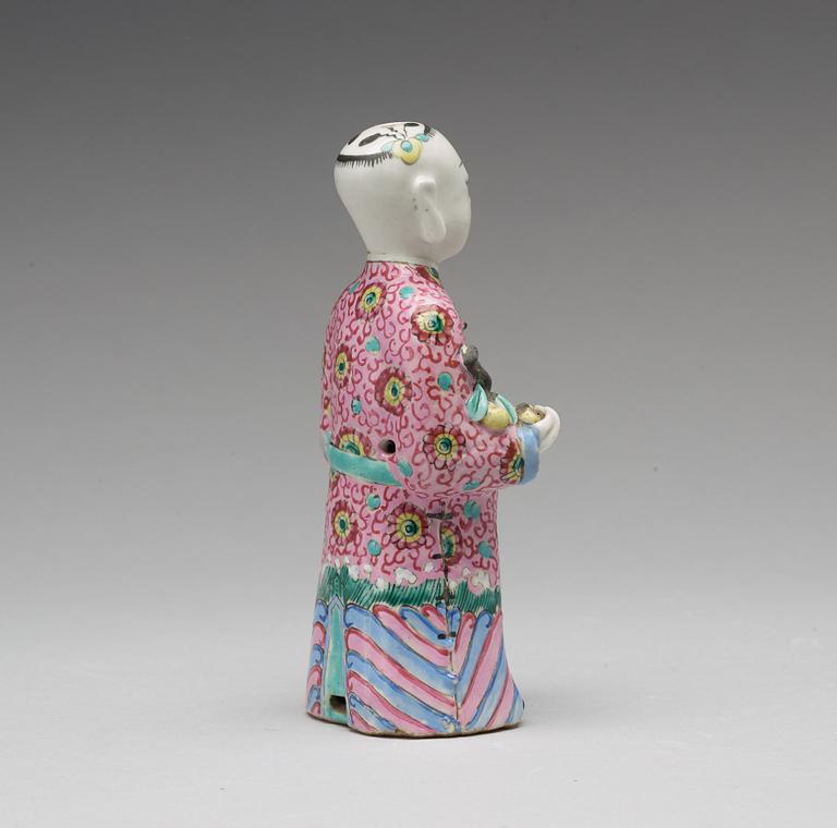 A famille rose figure of a laughing boy, Qing dynasty, circa 1800.