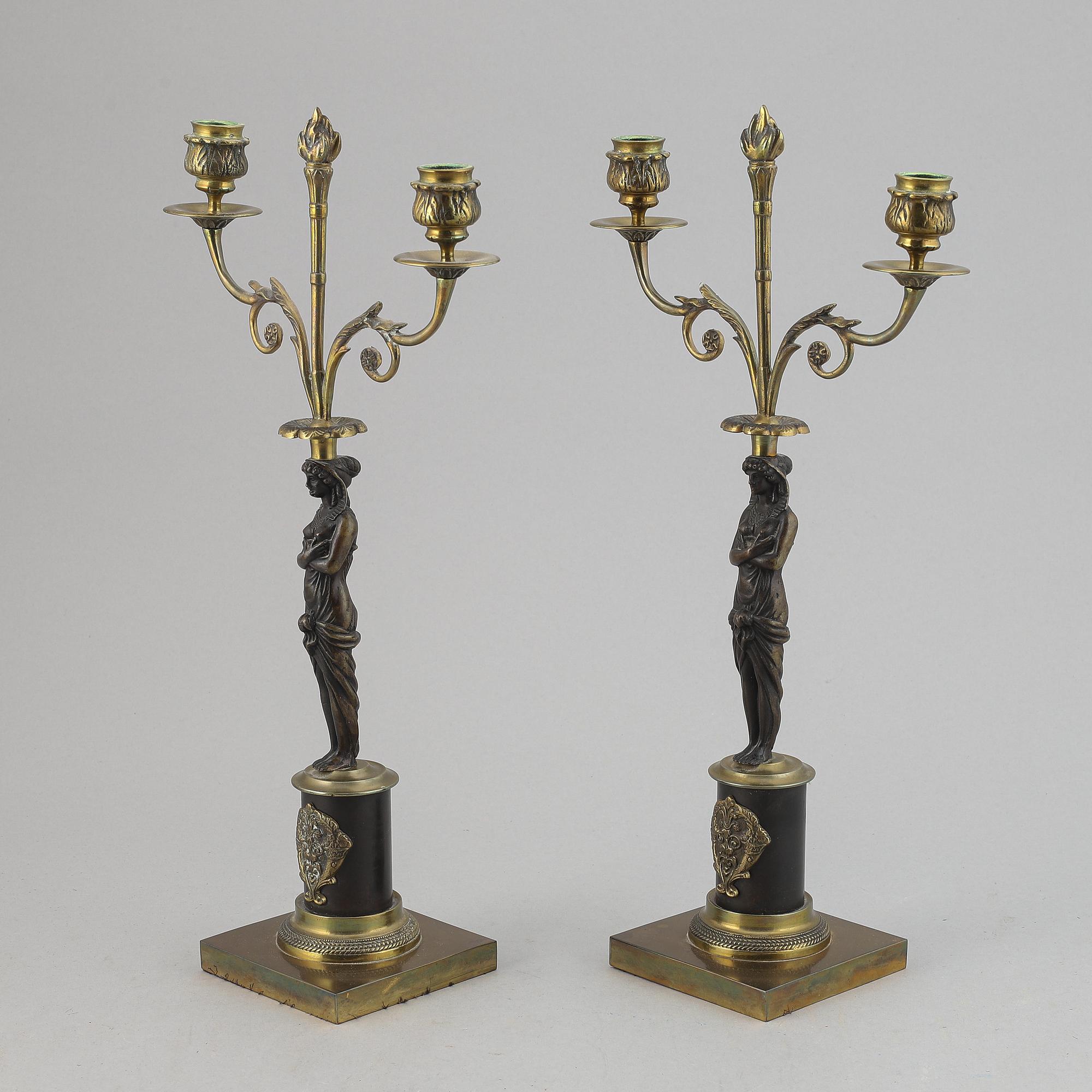 A pair of brass Empire style candle holders, 20th century.