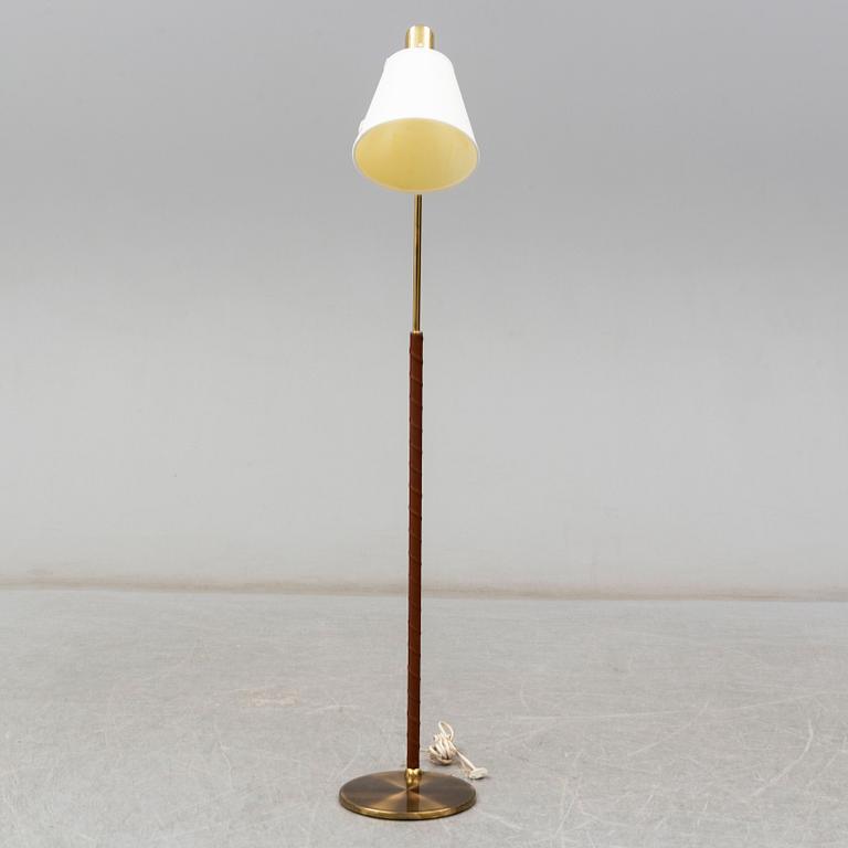 a brass and leather floor lamp from the second half of the 20th century.