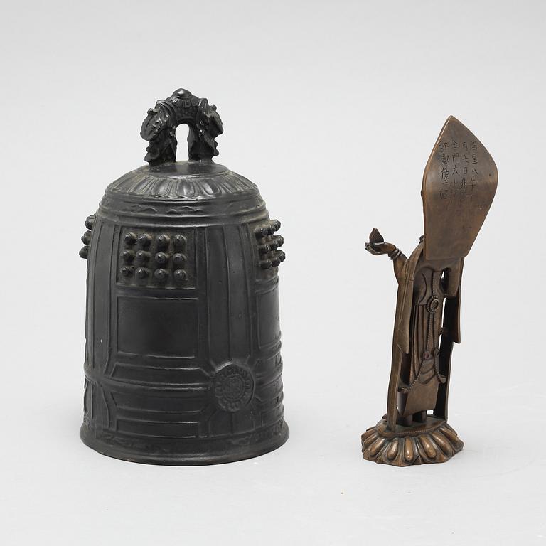 A Chinese temple bell and a figure of a deity, 20th Century.