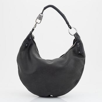 Gucci, a leather bag.