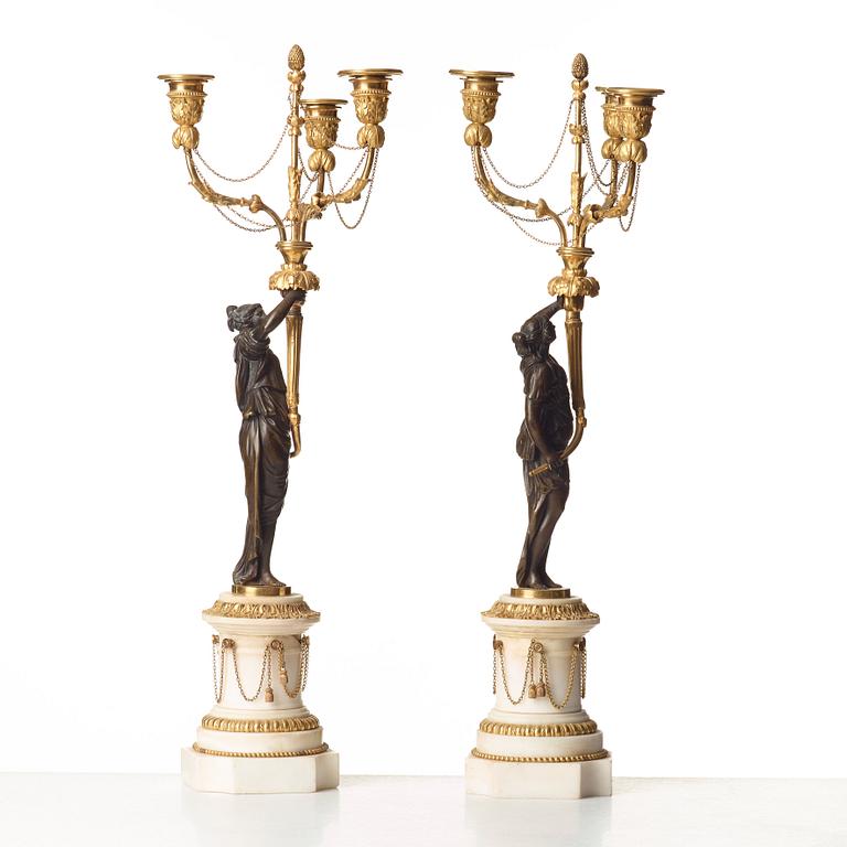 A pair of Louis XVI 18th century gilt and patinated bronze and marble three-light candelabra.