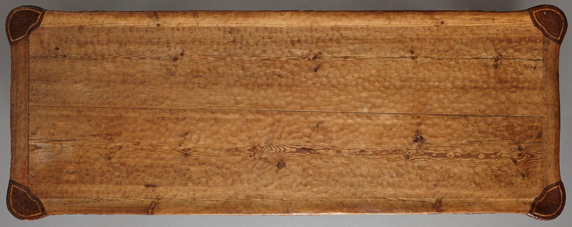 Gustaf Fjaestad, an Art Nouveau carved pine table, Arvika Sweden 1914, a double to the table in the Thiel Collection,