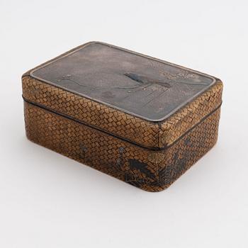 A Japanese woven bamboo box with metal inlaid shibuichi top early 20th century.