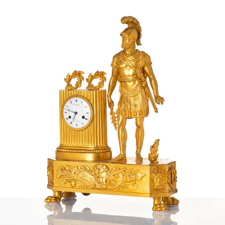 An Empire mantel clock, first part of the 19th century .