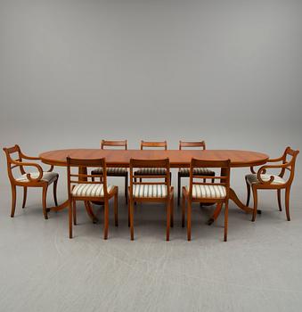 a late 20th century dining table with eight chairs.