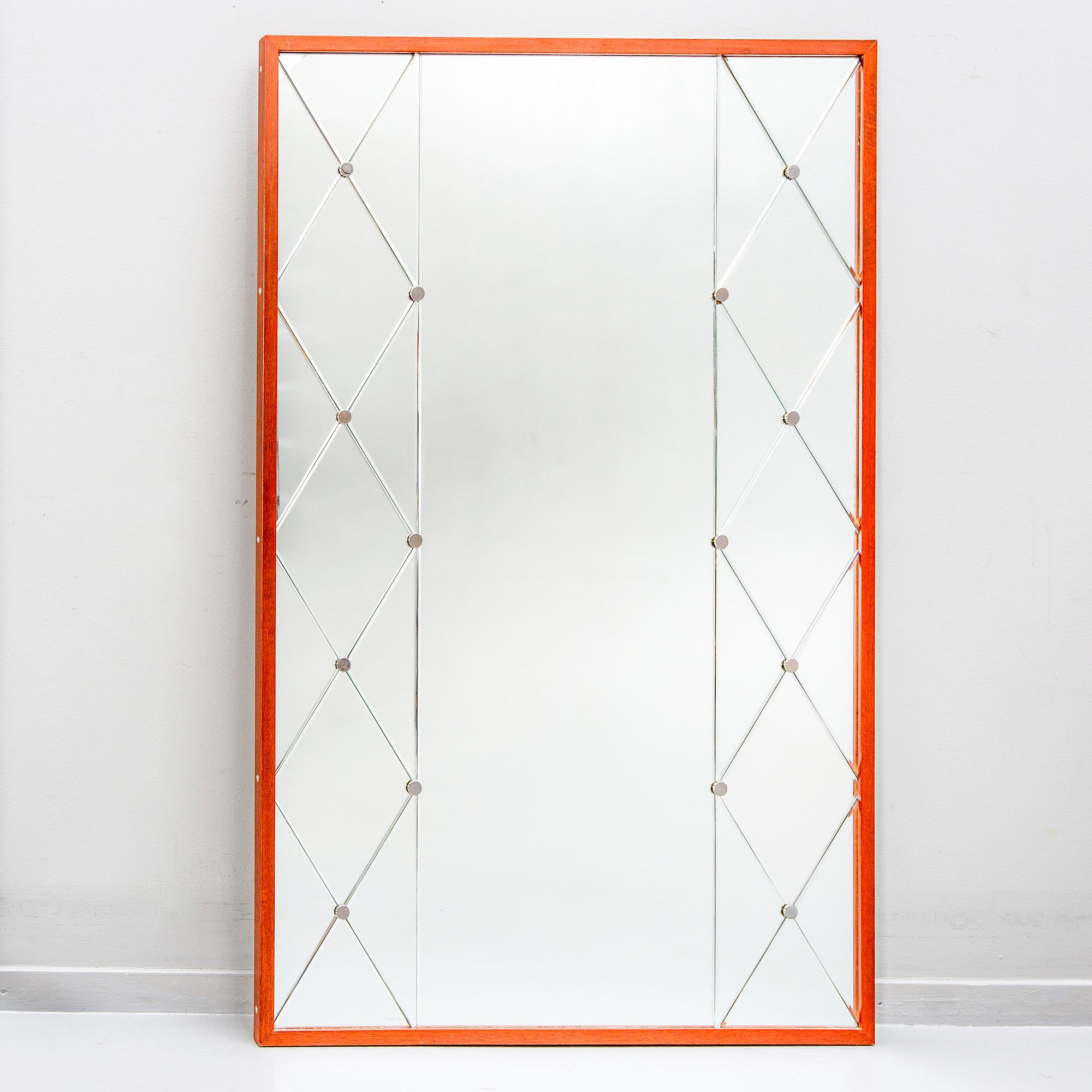 A 1960s teak mirror.