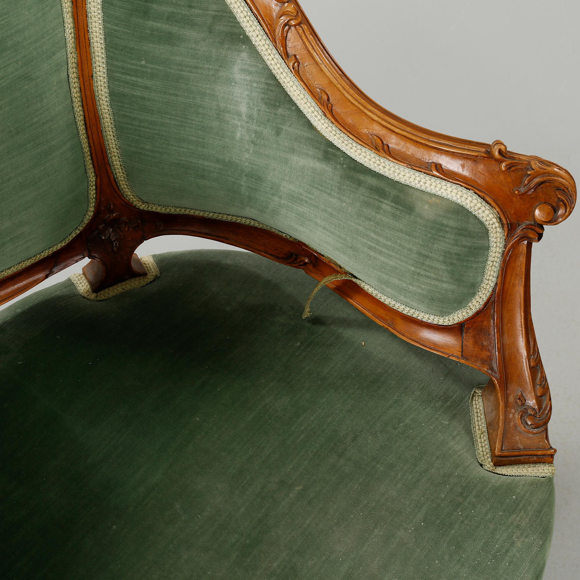 A rococo style sofa, two lounge chairs and a table, around the year 1900 and first half of the 20th century.