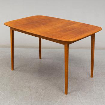 A late 20th Century teak veneered dinner table.