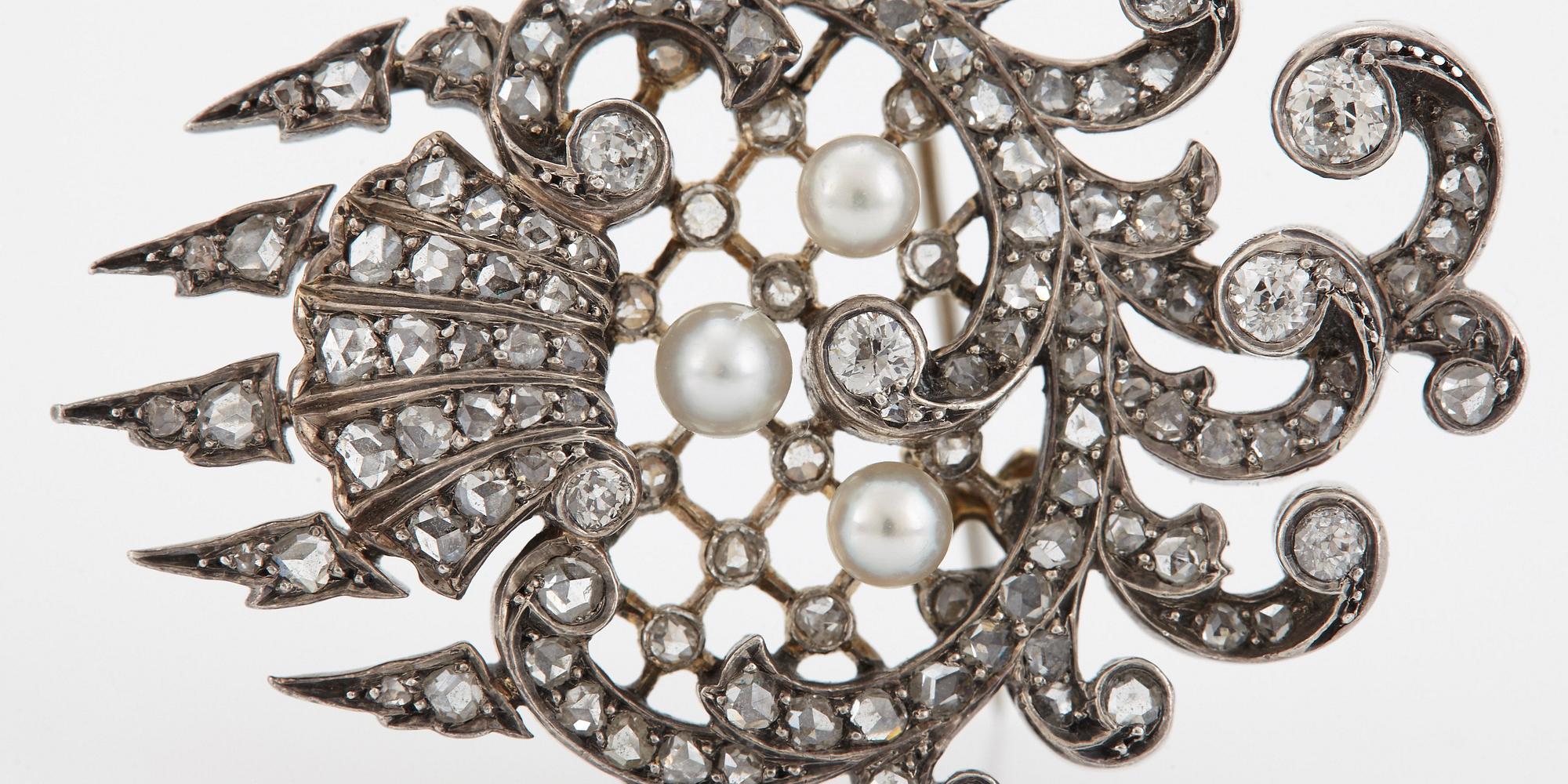 An 18K gold and silver brooch set with old- and rose-cut diamonds.