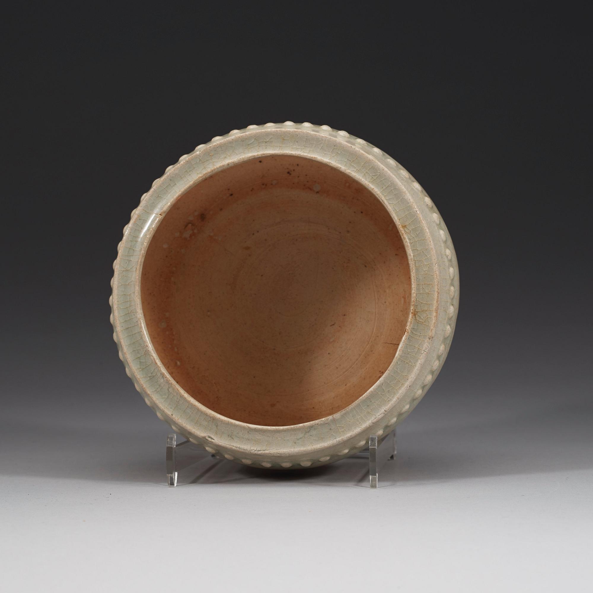 A pale celadon glazed tripod censer, presumably Yuan dynasty (1280-1367).