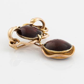 A 19th century 14K gold and garnet brooch with a detachable locket.