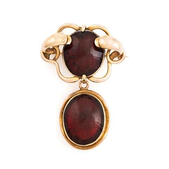 533. A 19th century 14K gold and garnet brooch with a detachable locket.