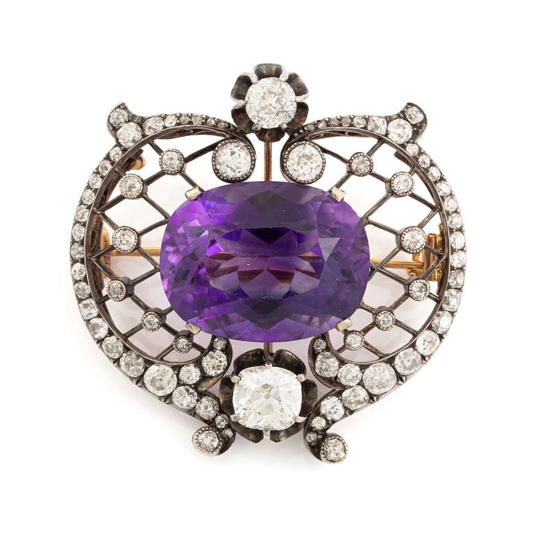 A brooch set with an amethyst and old-cut diamonds.