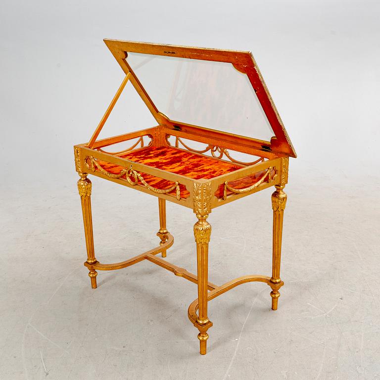 A gilded Louis XVI style display table first half of the 20th century.