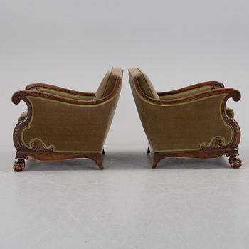 A pair of armchairs and a table, mid 20th century.