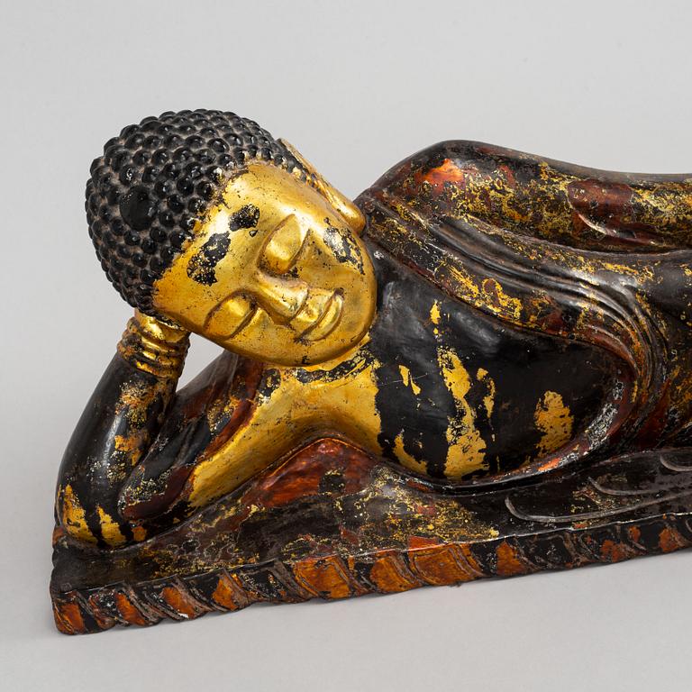 A large gilt and lacquered figure of reclining buddha, Thailand, circa 1900.