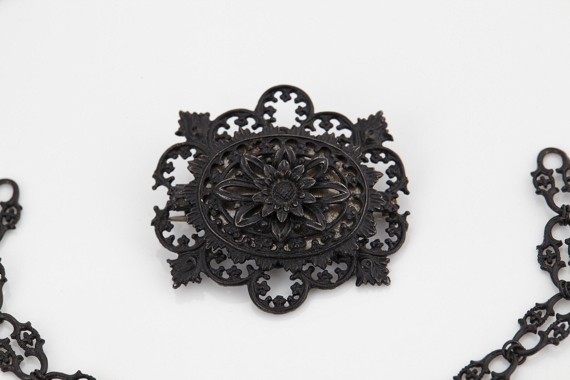A Berlin steel and iron parure comprising a necklace, two bracelets and a brooch.