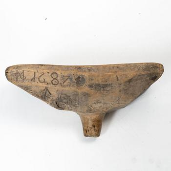 A Swedish carved wood milk funnel, dated 1687.