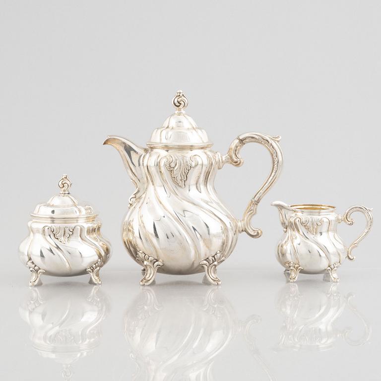 A German Rococo-Style Silver Coffee Pot, Creamer and Sugar Bowl, mark of MH Wilkens & Söhne, Bremen-Hemelingen.