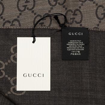 Gucci, a wool and silk mix "GG" jaquard shawl.